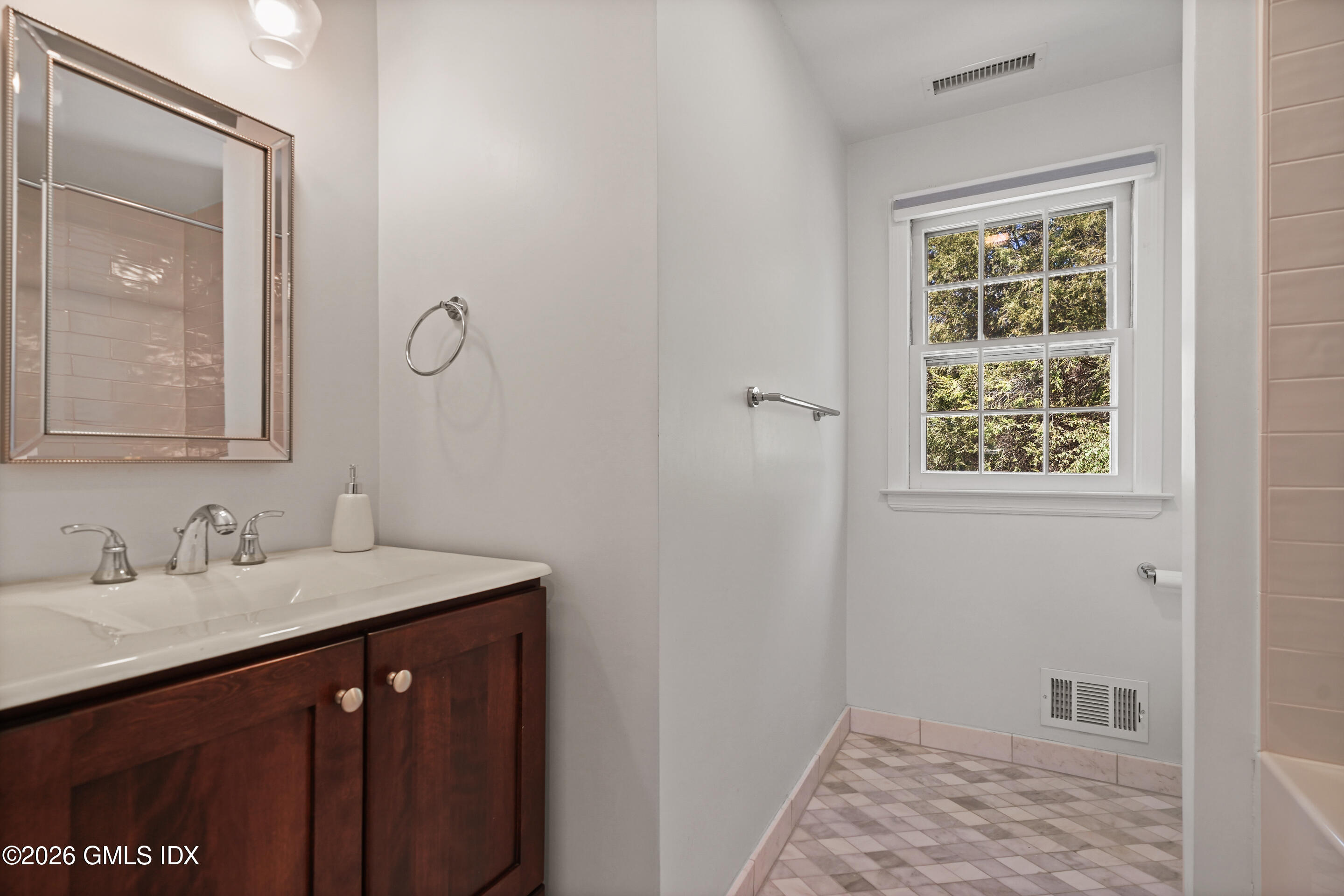 118 Butternut Hollow Road Greenwich, CT 06830 - Photo 30 of 44 a bathroom with a sink a vanity and a window