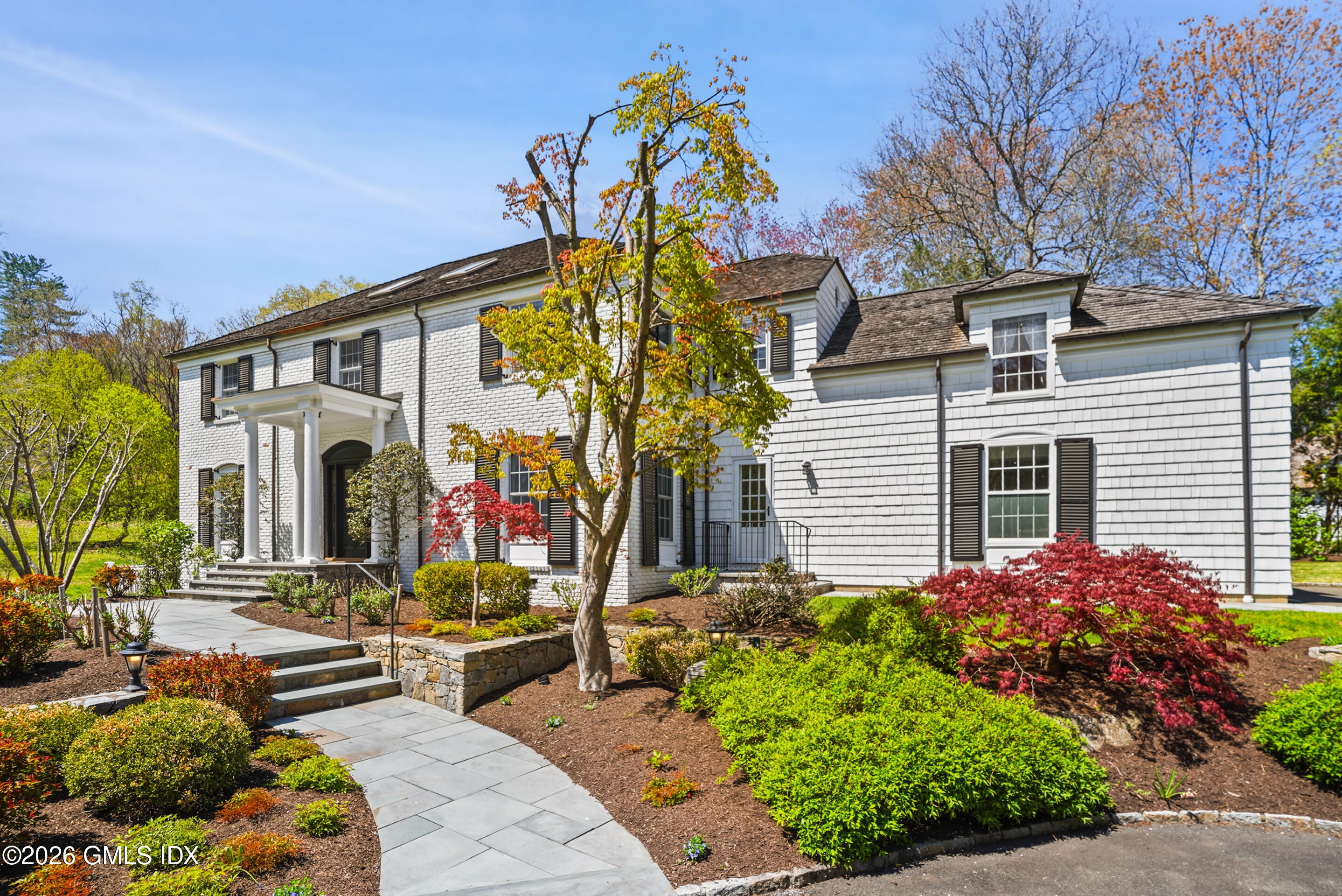 118 Butternut Hollow Road Greenwich, CT 06830 - Photo 3 of 44 a front view of a house with a yard