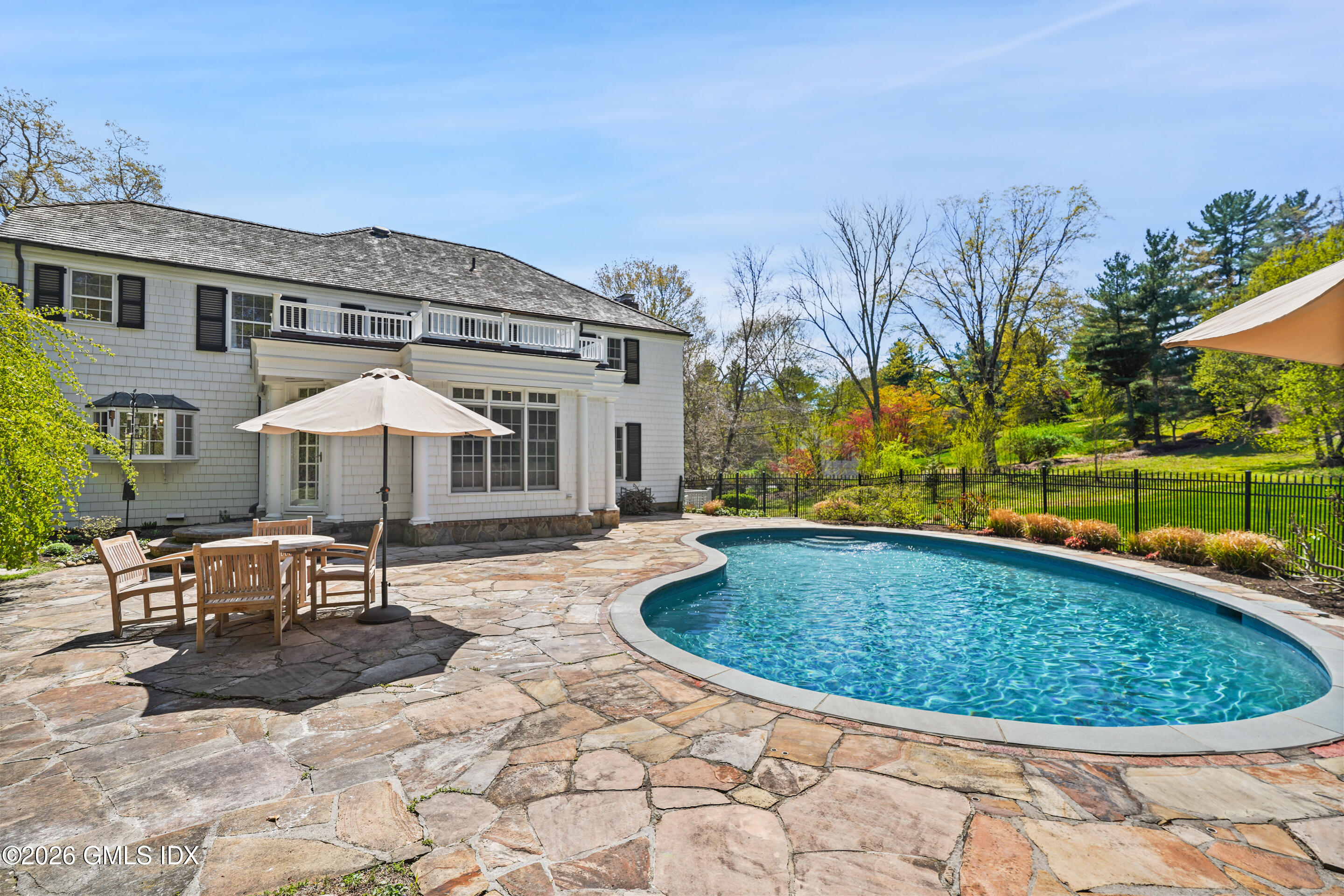 118 Butternut Hollow Road Greenwich, CT 06830 - Photo 37 of 44 a view of a swimming pool with a patio