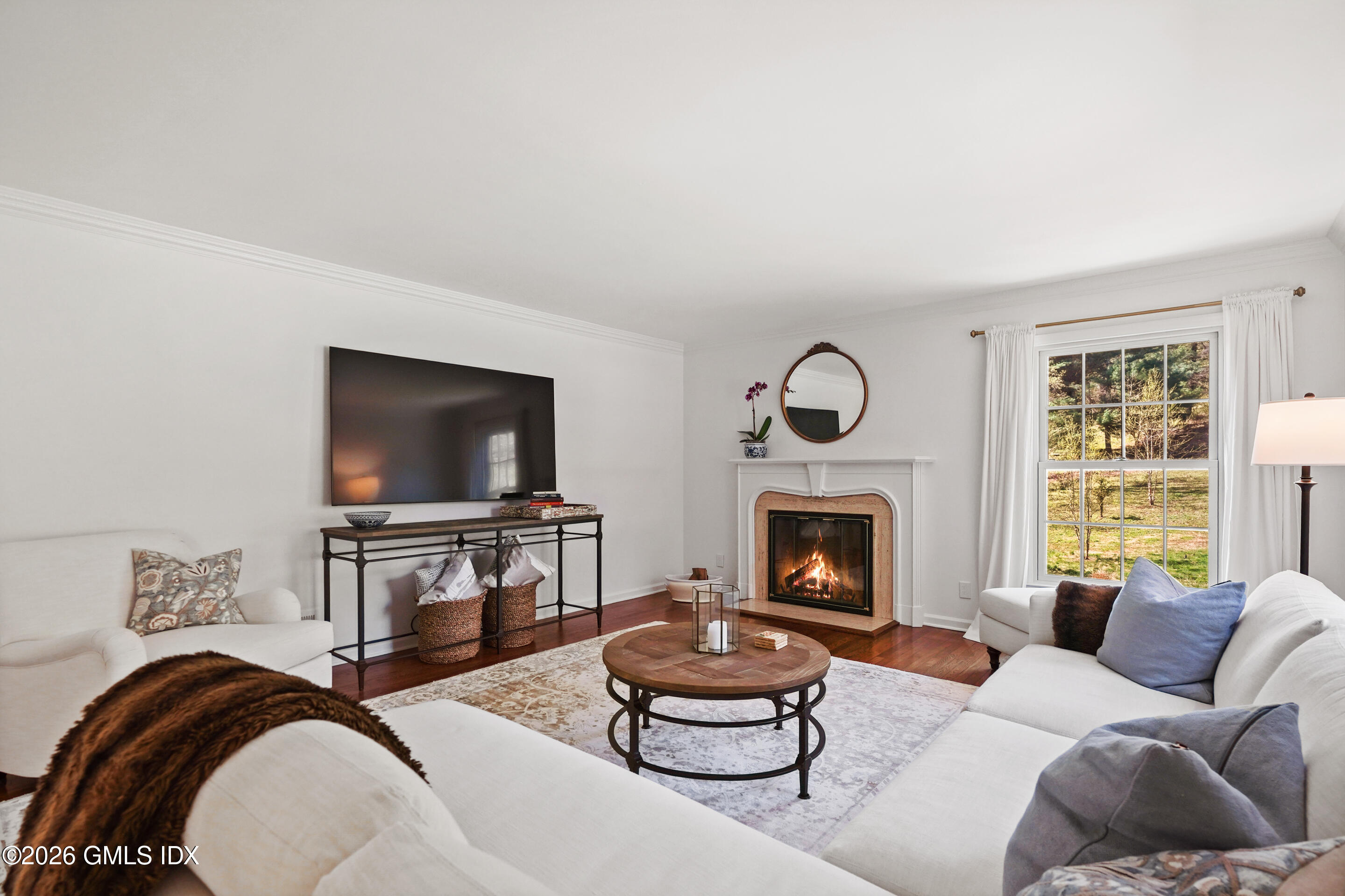 118 Butternut Hollow Road Greenwich, CT 06830 - Photo 8 of 44 a living room with furniture a fireplace and a flat screen tv