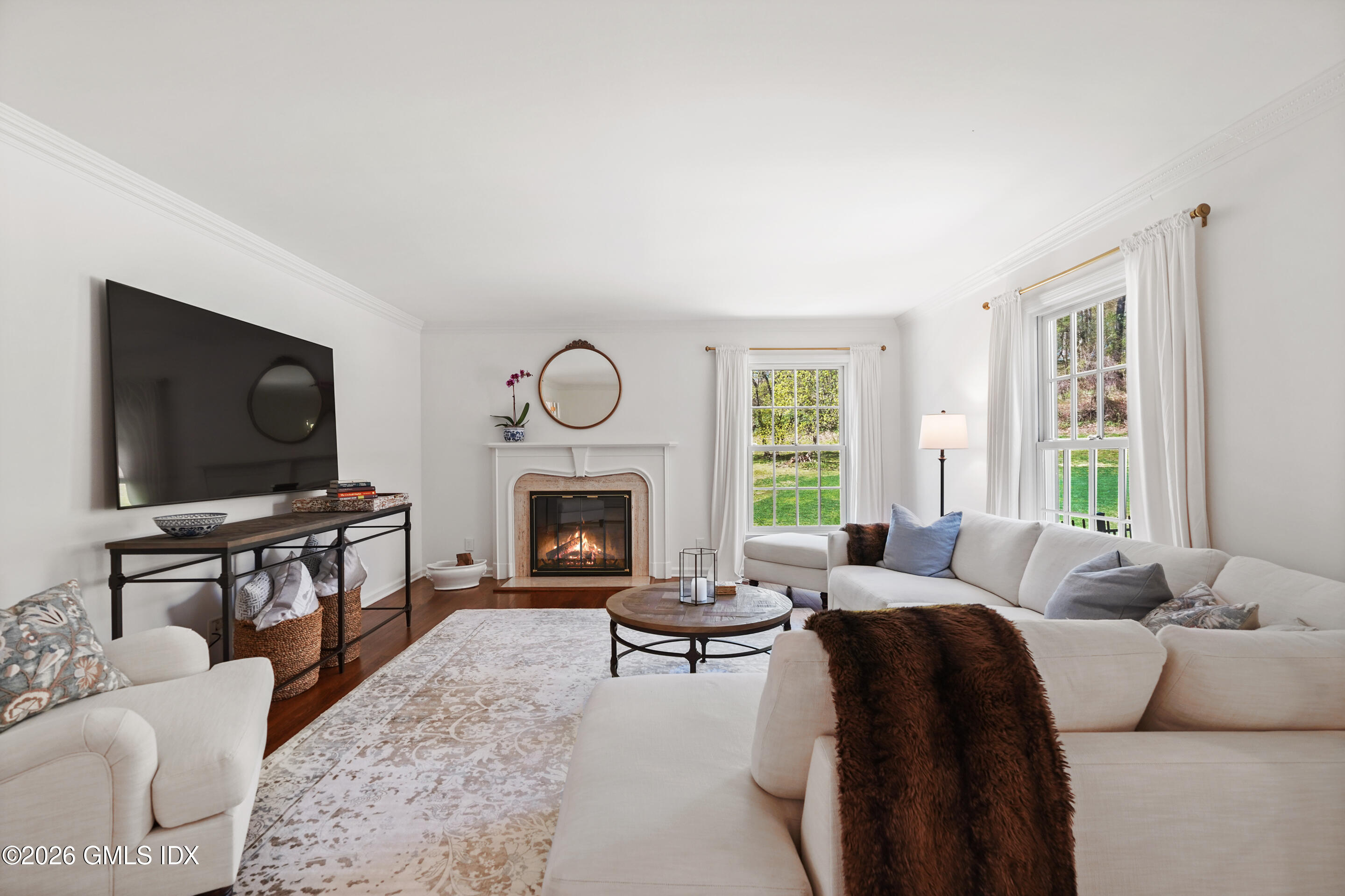 118 Butternut Hollow Road Greenwich, CT 06830 - Photo 9 of 44 a living room with furniture a flat screen tv and a fireplace