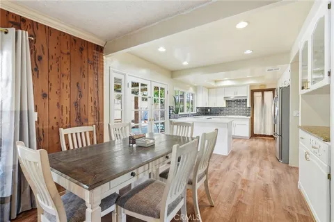 a dining room with furniture and a floor to ceiling window