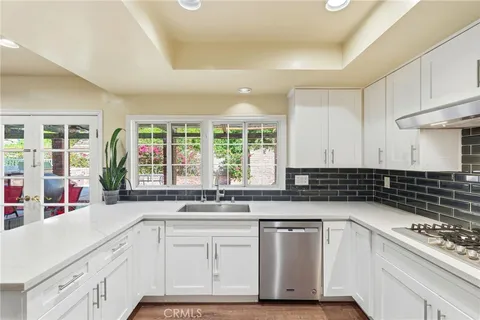 a kitchen with granite countertop a sink and a stove