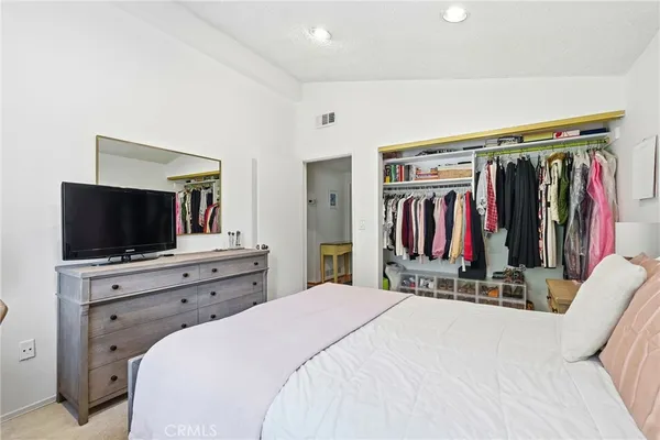 a bedroom with a bed and a flat screen tv