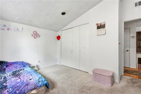 a bedroom with a bed and a cabinets