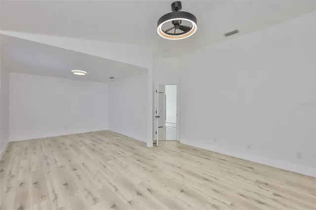 a view of a livingroom with wooden floor and window