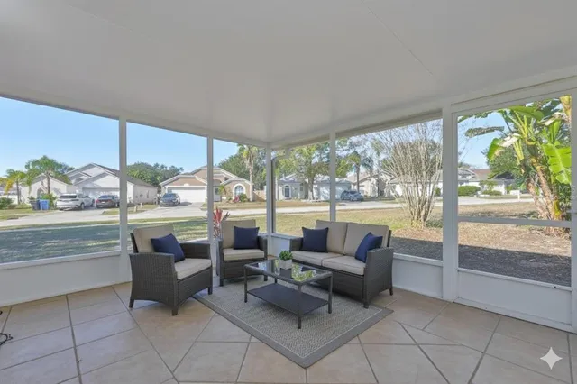 a view of a hallway with wooden floor and a chandelier