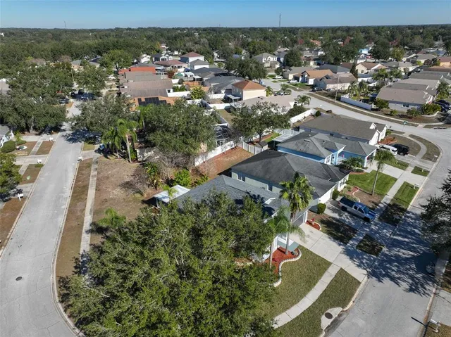 an aerial view of a house with a yard and lake view