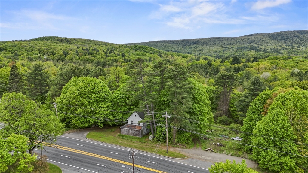 249 Pittsfield Road Lenox, MA 01240 - Photo 5 of 5 a view of a lush green outdoor space with a house in the background