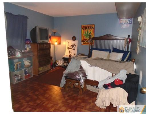 25 Hilltop Road Edison, NJ 08820 - Photo 14 of 21 a living room with furniture and a lamp
