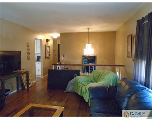 25 Hilltop Road Edison, NJ 08820 - Photo 3 of 21 a living room with furniture and a flat screen tv