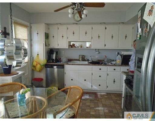 25 Hilltop Road Edison, NJ 08820 - Photo 6 of 21 a kitchen with stainless steel appliances kitchen island granite countertop a refrigerator a sink a stove and white cabinets