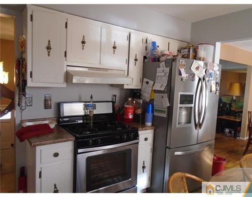 25 Hilltop Road Edison, NJ 08820 - Photo 7 of 21 a kitchen with stainless steel appliances granite countertop a refrigerator sink and stove