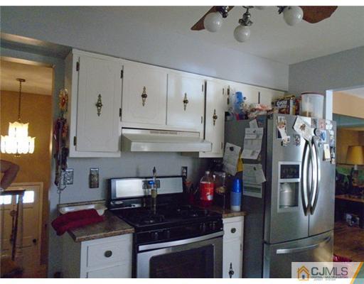25 Hilltop Road Edison, NJ 08820 - Photo 8 of 21 a kitchen with stainless steel appliances granite countertop a sink stove and refrigerator