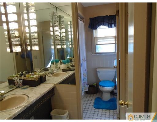 25 Hilltop Road Edison, NJ 08820 - Photo 9 of 21 a bathroom with a sink toilet and a mirror