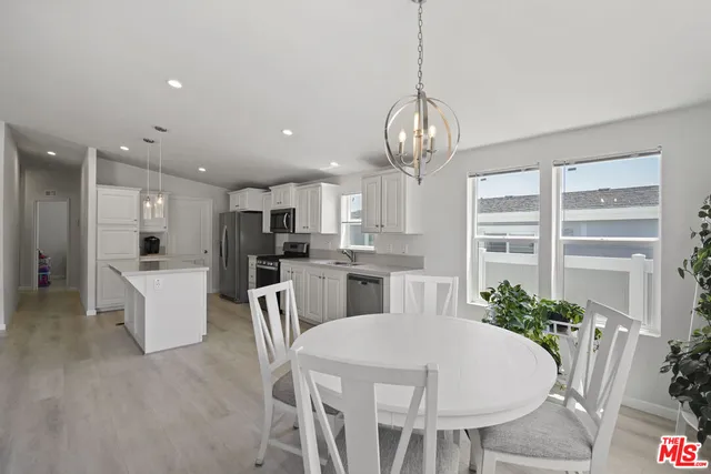a large kitchen with a table and chairs