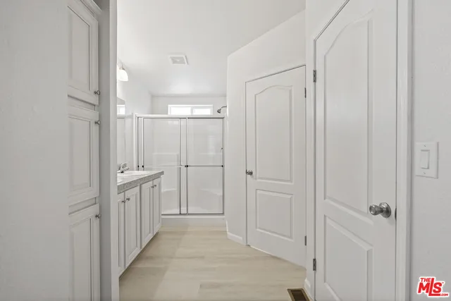 a view of a hallway with white doors