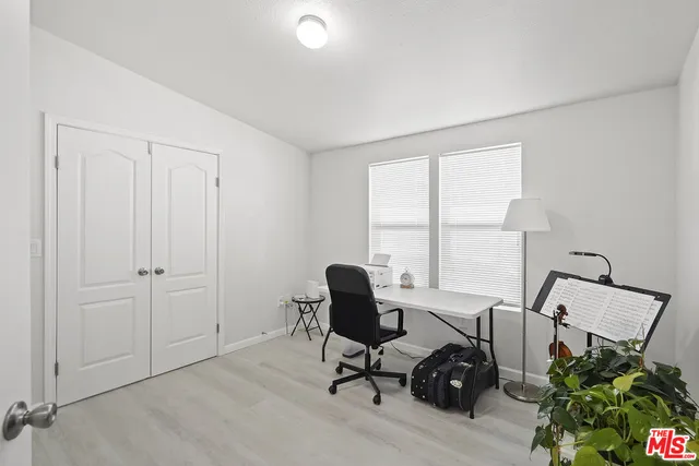 a view of a workspace with furniture and a window