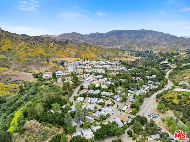 a view of a town with mountains in the background