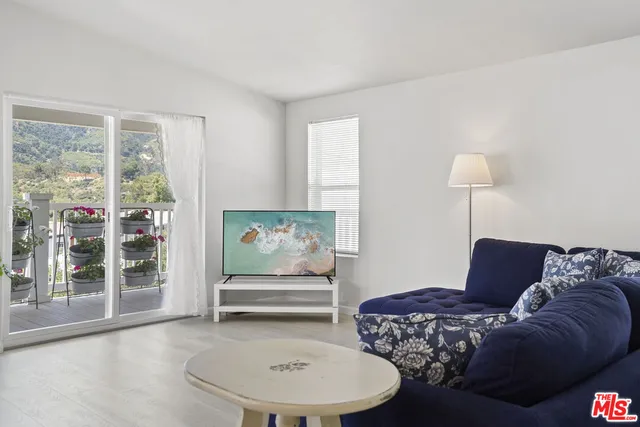 a living room with furniture and a lamp