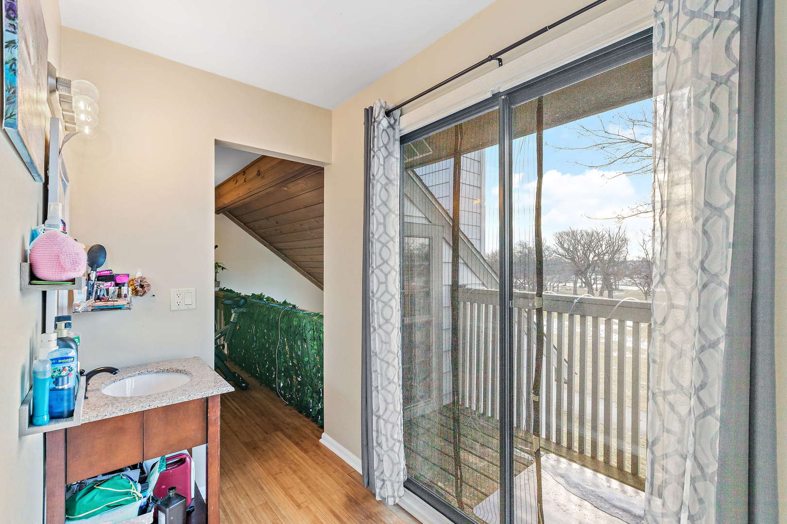 772 Chandler Road, Unit 772 Gurnee, IL 60031 - Photo 18 of 30 a living room with a floor to ceiling window and wooden floor