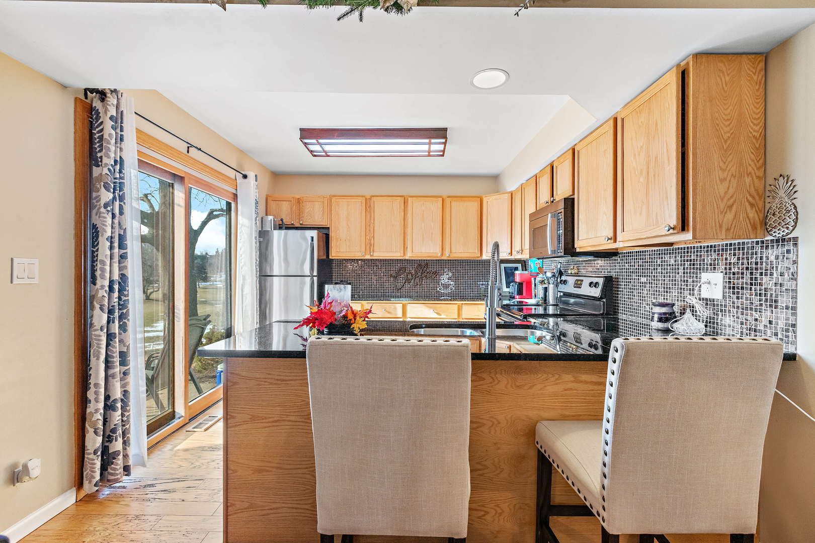 772 Chandler Road, Unit 772 Gurnee, IL 60031 - Photo 8 of 30 a kitchen with a refrigerator and a chair