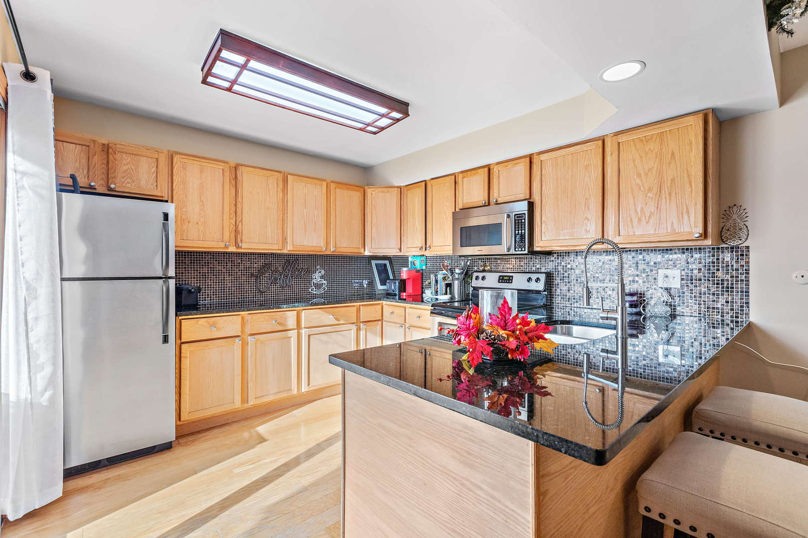 772 Chandler Road, Unit 772 Gurnee, IL 60031 - Photo 10 of 30 a kitchen with stainless steel appliances granite countertop a refrigerator sink stove and microwave