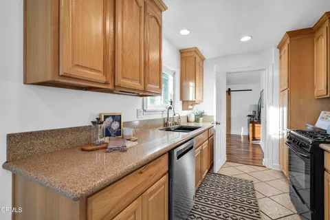 a kitchen with stainless steel appliances granite countertop a sink stove and cabinets