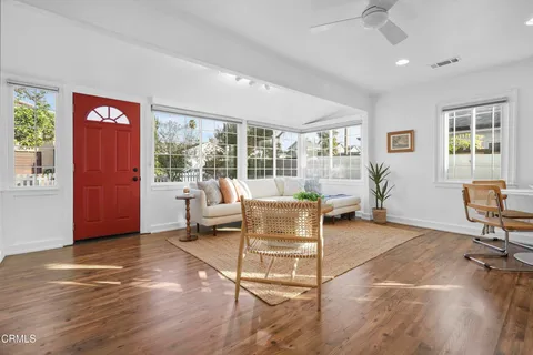 a living room with furniture and a floor to ceiling window