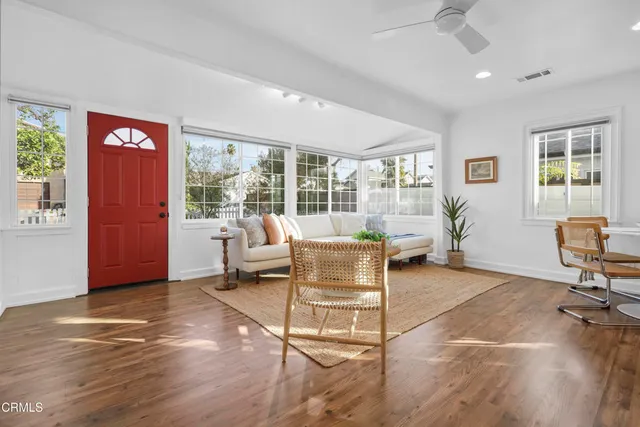 a living room with furniture and a floor to ceiling window