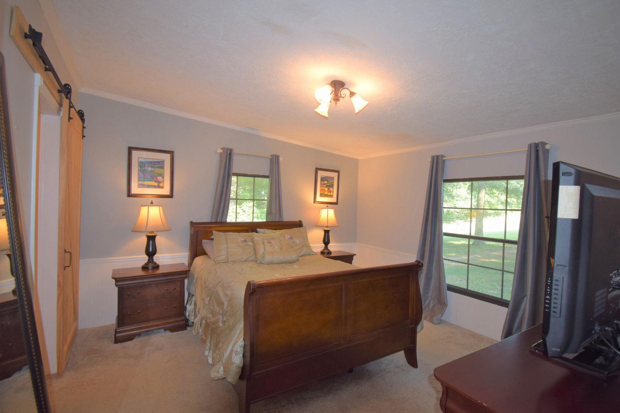 279 Hester Road Portland, TN 37148 - Photo 14 of 38 a bedroom with a bed and a flat tv screen on dresser