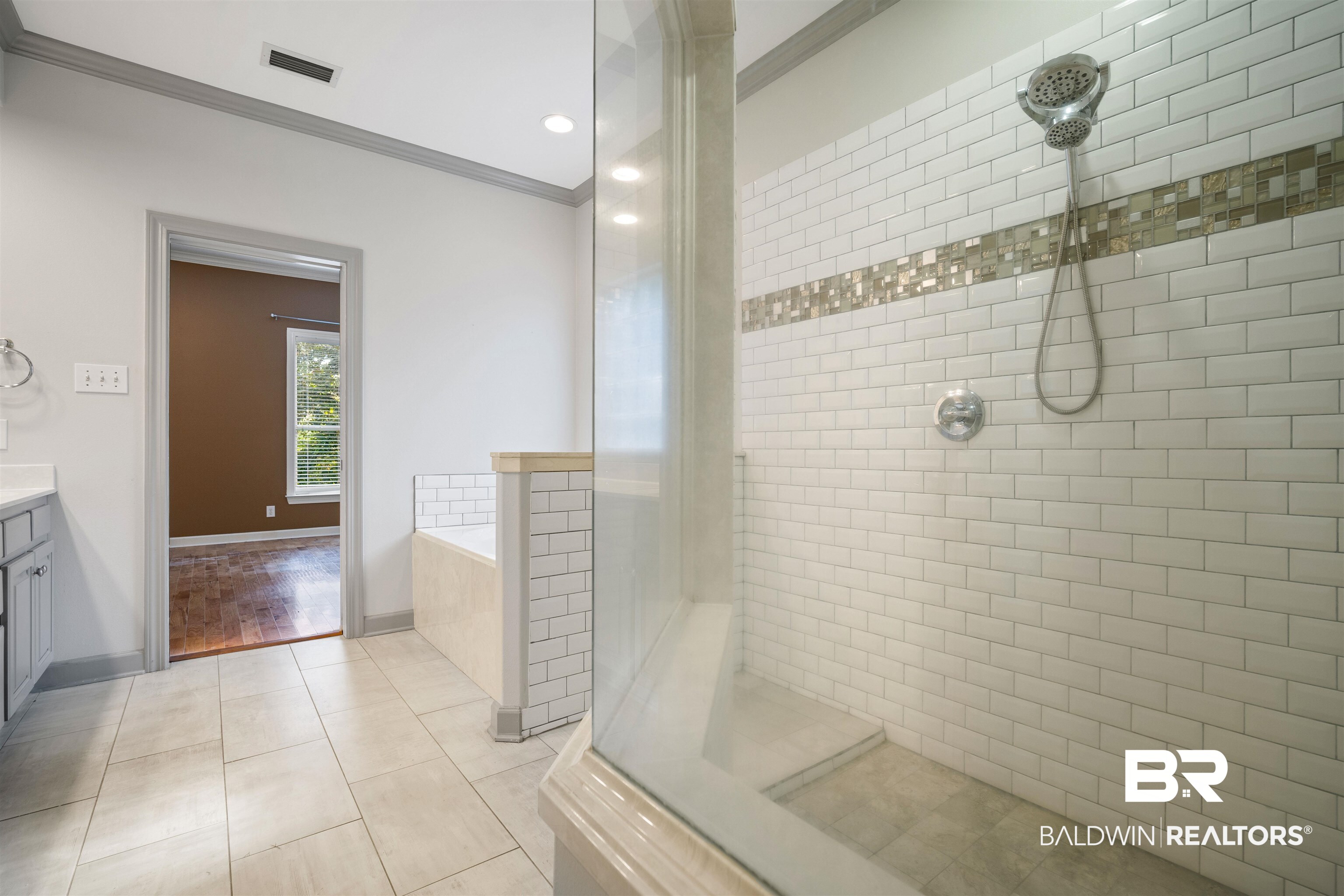 204 General Canby Loop Daphne, AL 36527 - Photo 19 of 36 Bathroom featuring tile patterned floors, crown molding, vanity, and plus walk in shower