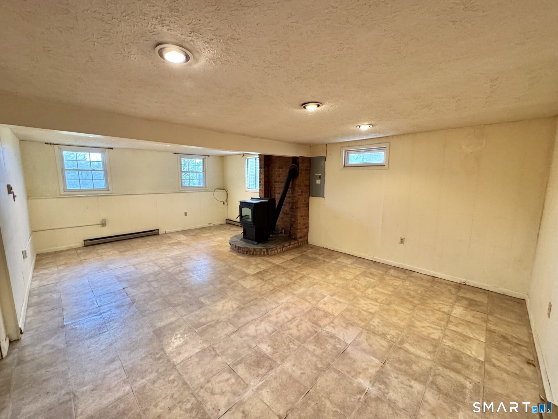 319 Jones Hollow Road Marlborough, CT 06447 - Photo 15 of 23 Finished lower level with pellet stove.