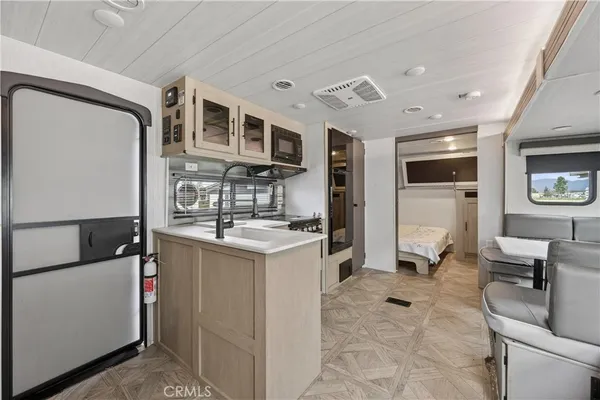 a kitchen with stainless steel appliances granite countertop a sink and a refrigerator