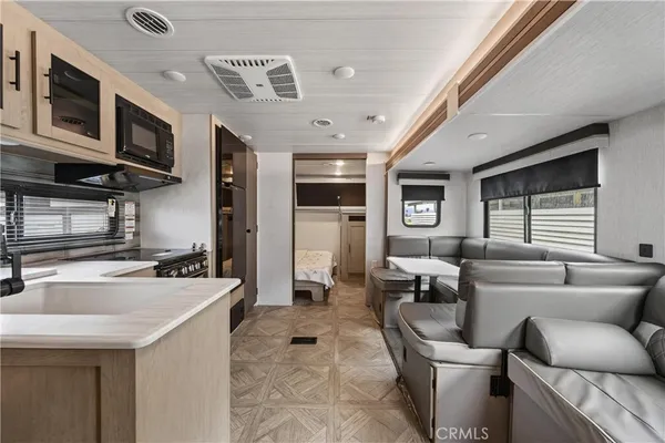 a kitchen with stainless steel appliances granite countertop a sink and dishwasher a stove top oven with wooden floor