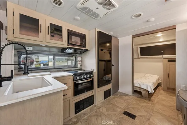 a kitchen with stainless steel appliances granite countertop a sink and a stove top oven