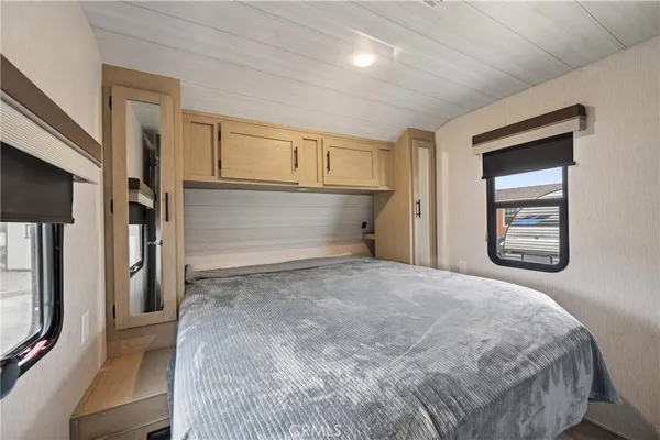 a bedroom with a bed and a window