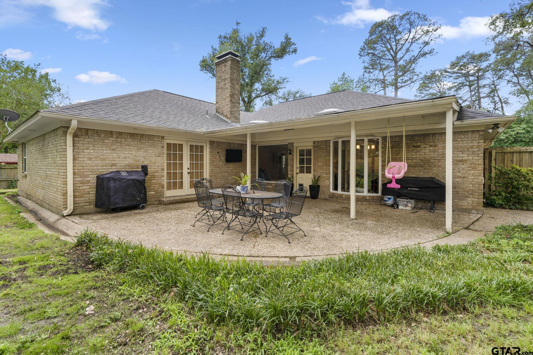 3608 Pollard Drive Tyler, TX 75701 - Photo 12 of 14 a view of a patio with table and chairs potted plants and large tree