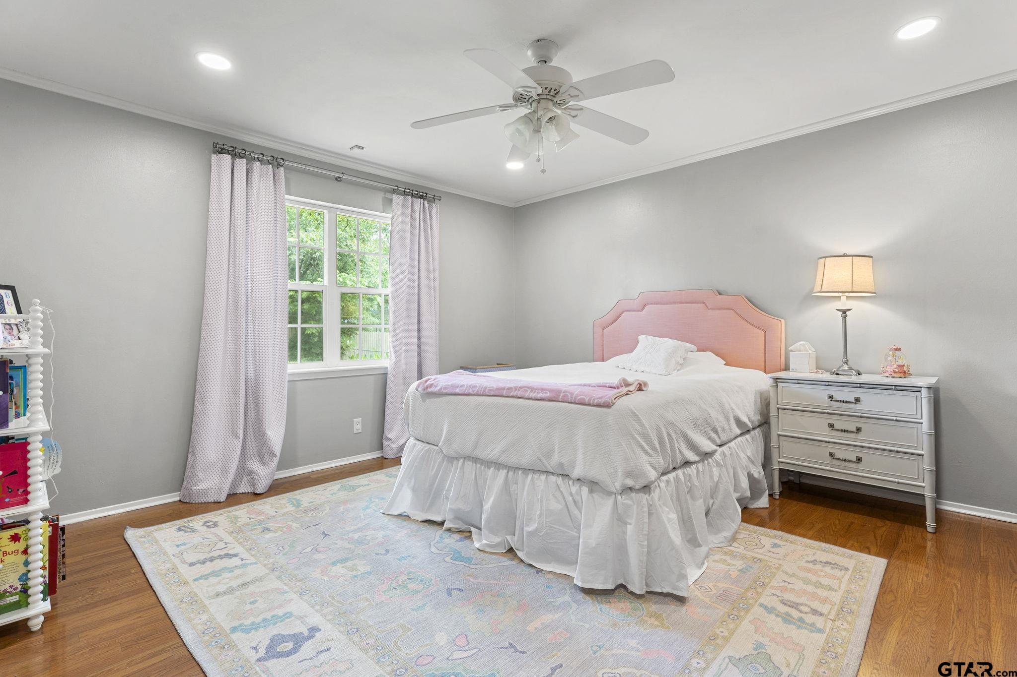 3608 Pollard Drive Tyler, TX 75701 - Photo 10 of 14 a bedroom with a bed and a chandelier