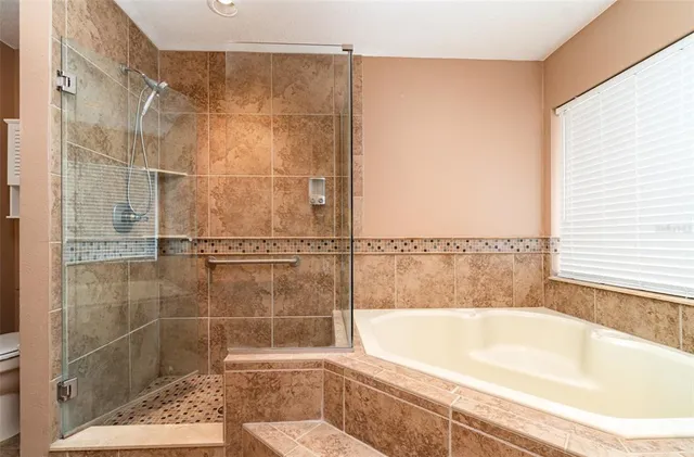 a bathroom with a bathtub and a shower