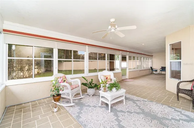 a living room filled with furniture and a potted plant