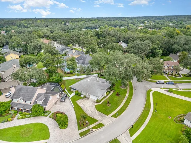 an aerial view of a house with a swimming pool outdoor seating and yard
