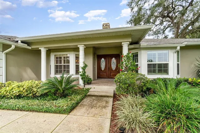 front view of a house with potted plants
