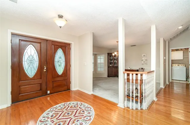 a kitchen with kitchen island granite countertop a sink cabinets and wooden floor