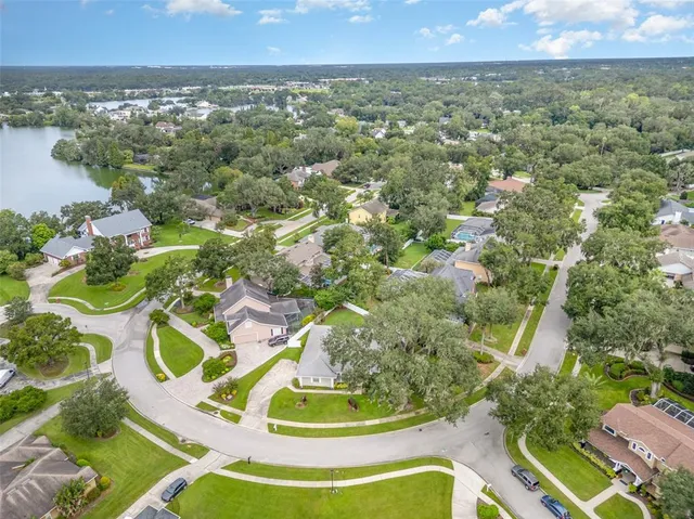 an aerial view of residential building with outdoor space and trees