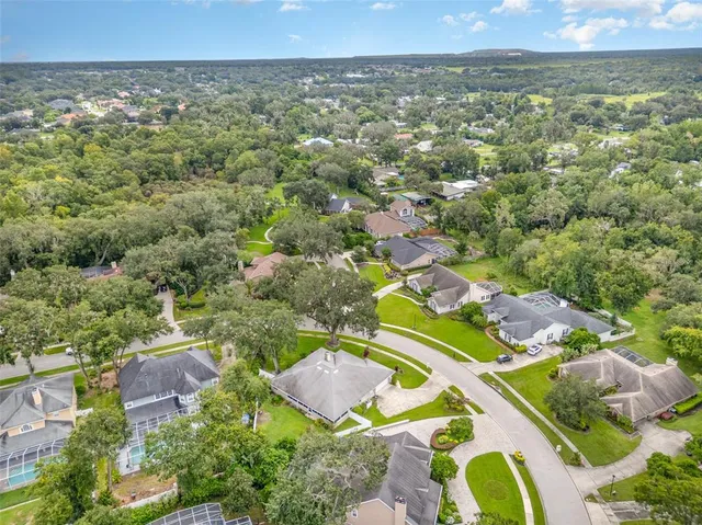 an aerial view of a house with a yard and lake view