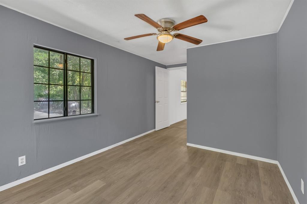 84 Natchez Road Pottsboro, TX 75076 - Photo 22 of 37 an empty room with a window and a ceiling fan