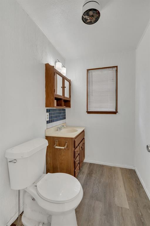 84 Natchez Road Pottsboro, TX 75076 - Photo 23 of 37 a bathroom with a toilet a sink and mirror