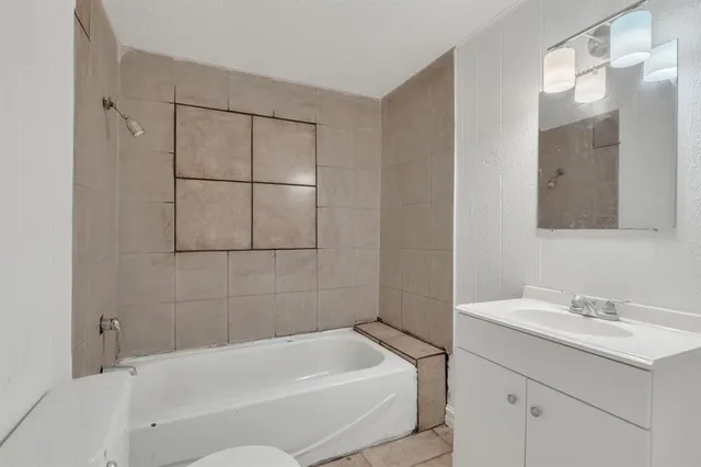 a bathroom with a bathtub and a sink