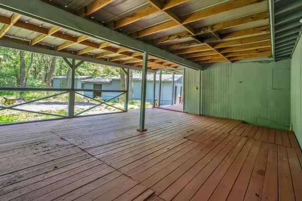 a view of porch with wooden floor